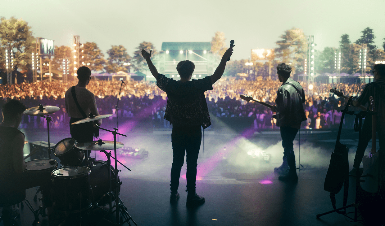 Band performing on stage at outdoor concert.
