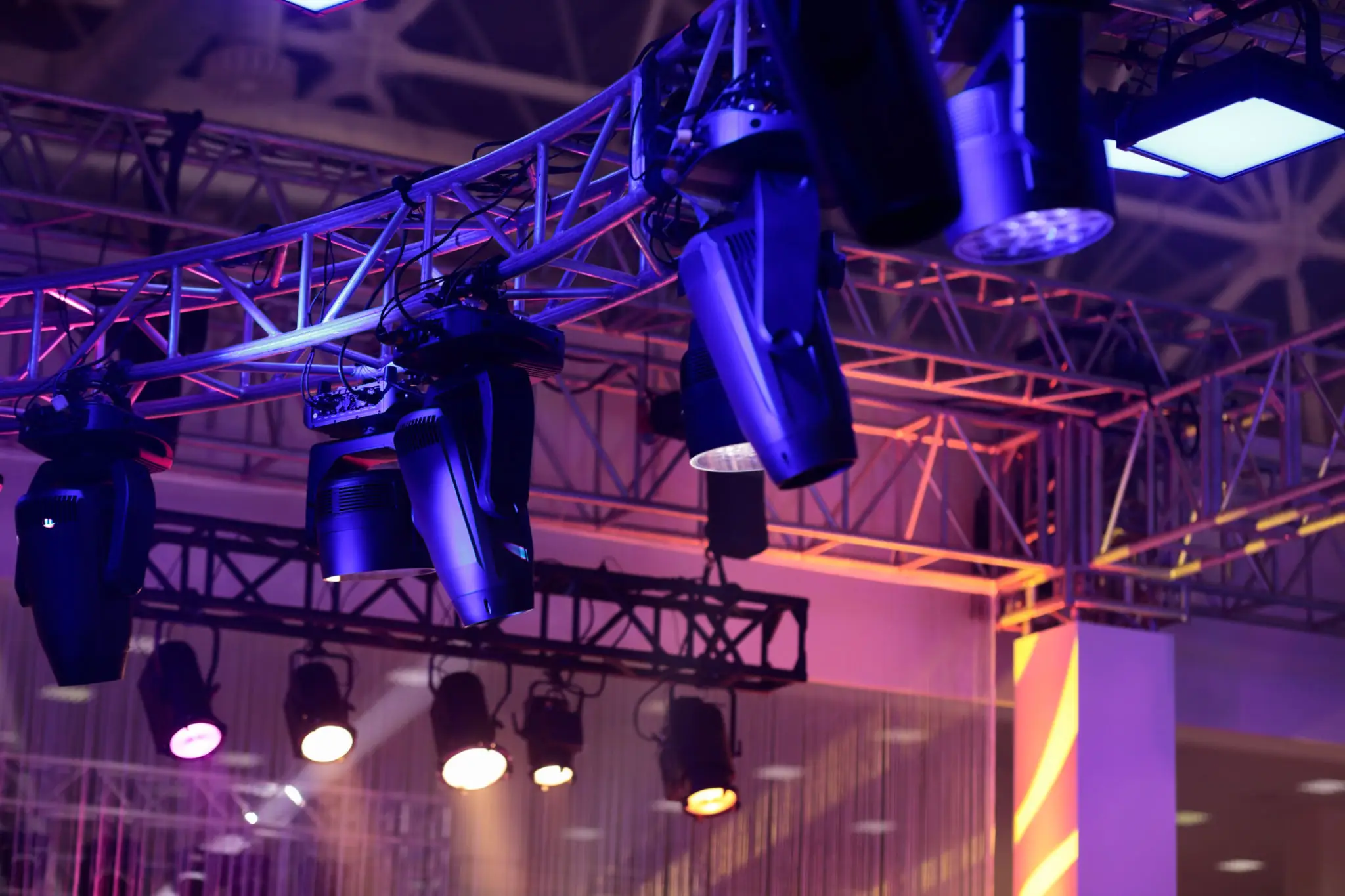 Overhead stage lighting rig with colored spotlights