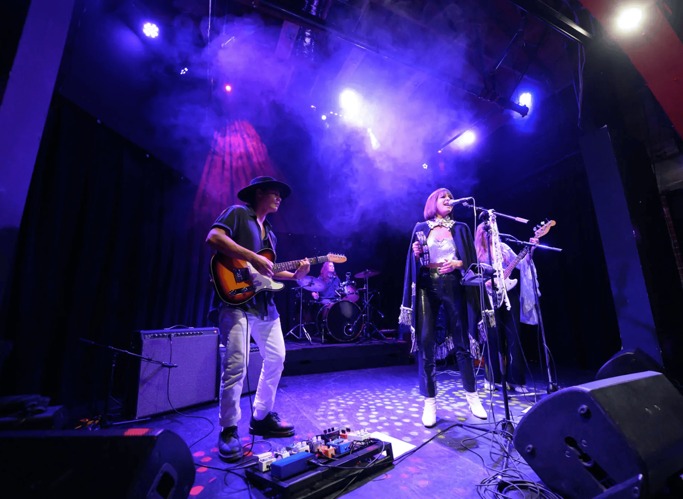 Band performing under purple stage lights