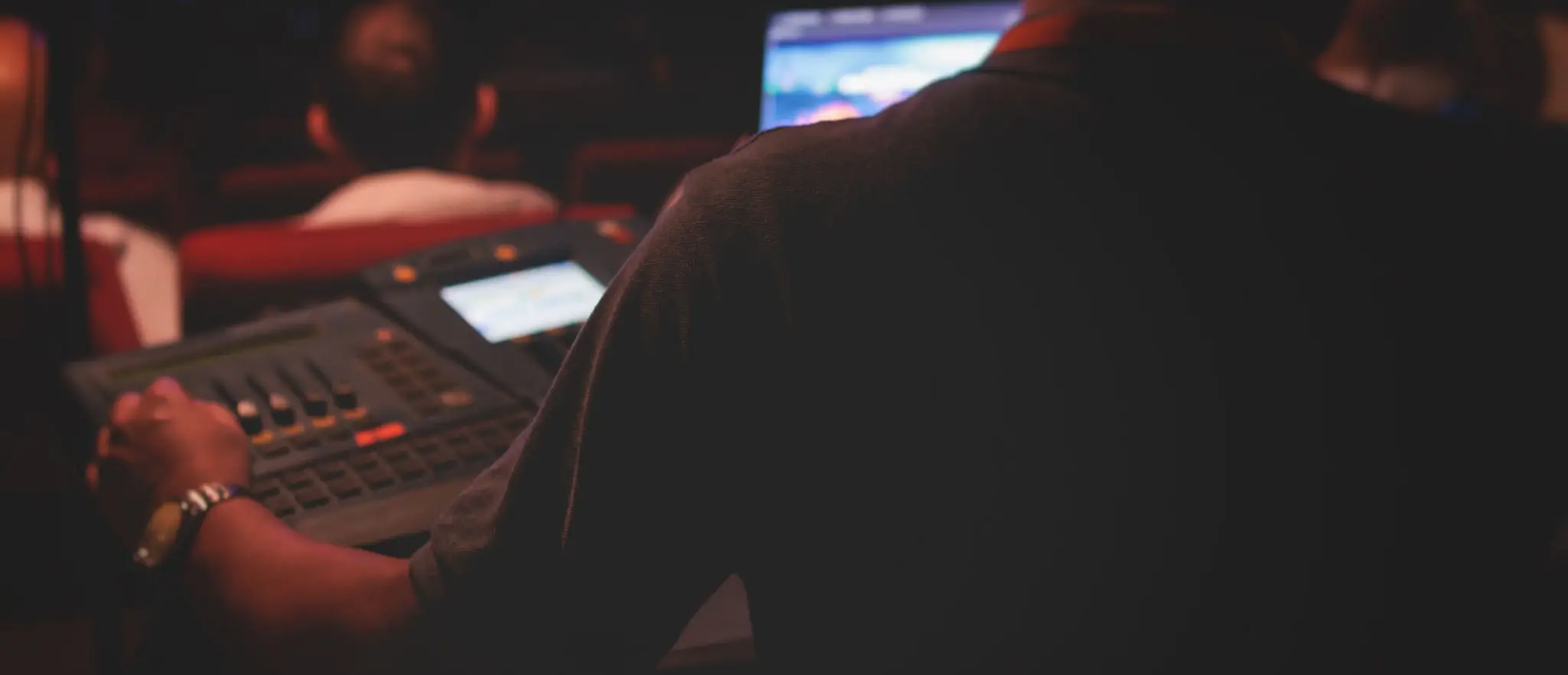 Audio engineer operating mixing console at event