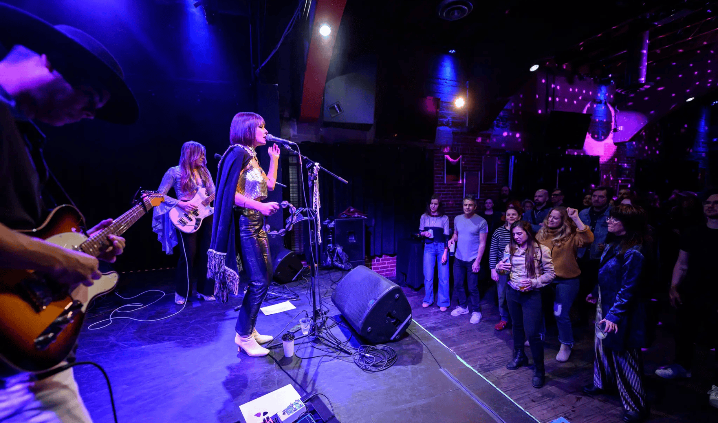 Band performing onstage to attentive nightclub audience